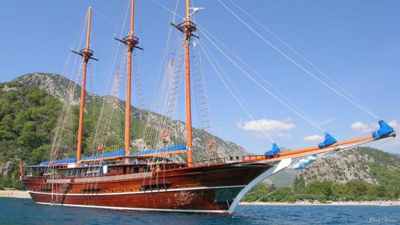 The gulet Bahrieli C with 12 cabins, starting point Marmaris, in front of a picturesque coastal landscape.